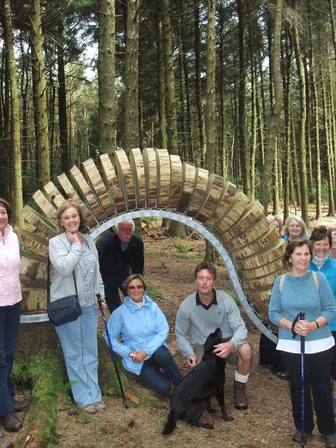 A group of people posing next to a sculpture on the Pendle Sculpture Trail