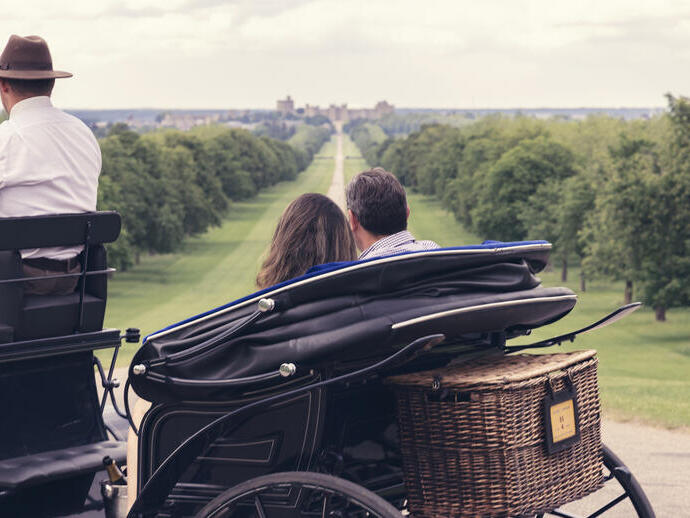 Una coppia su una carrozza che guarda lungo il Long Walk a Windsor