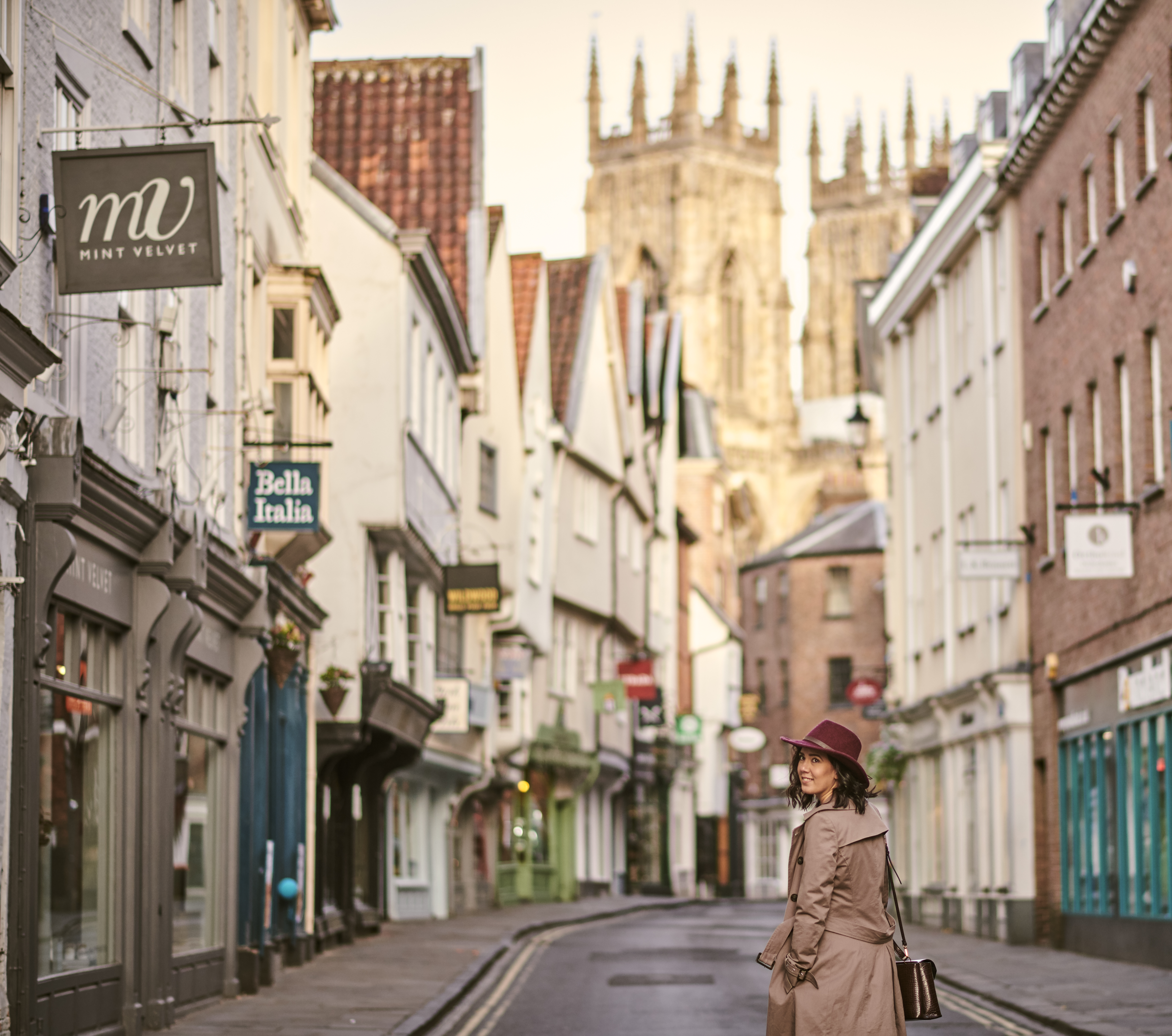Woman walking through a narrow historic street in a city
