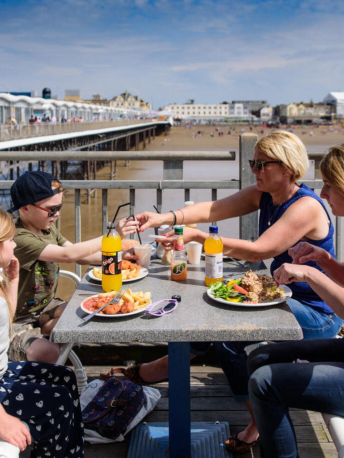 Una familia almorzando junto a la playa