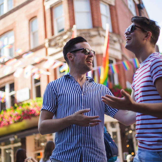 Young men talk outside a bar