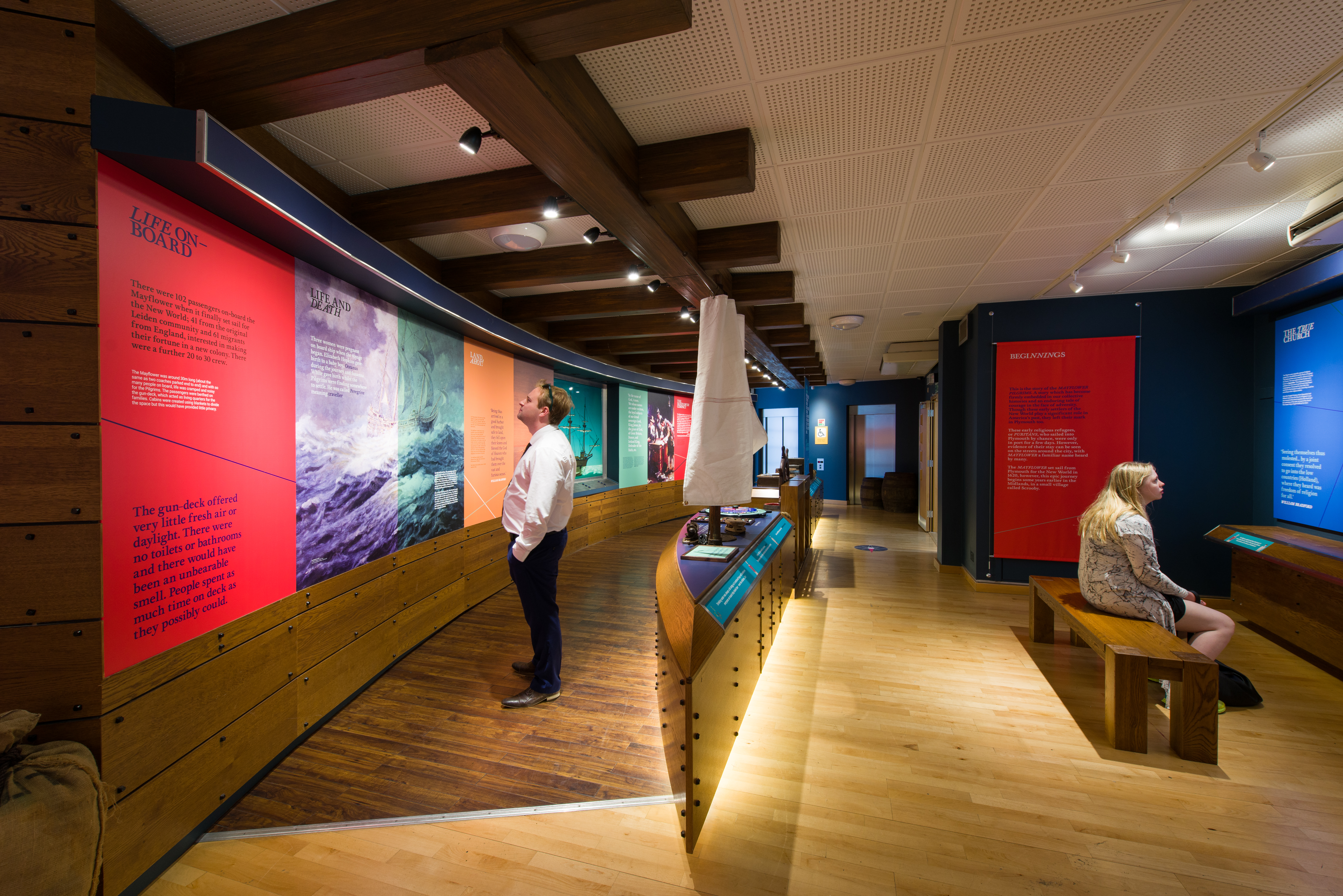 People looking at exhibits inside the Mayflower Museum in Plymouth