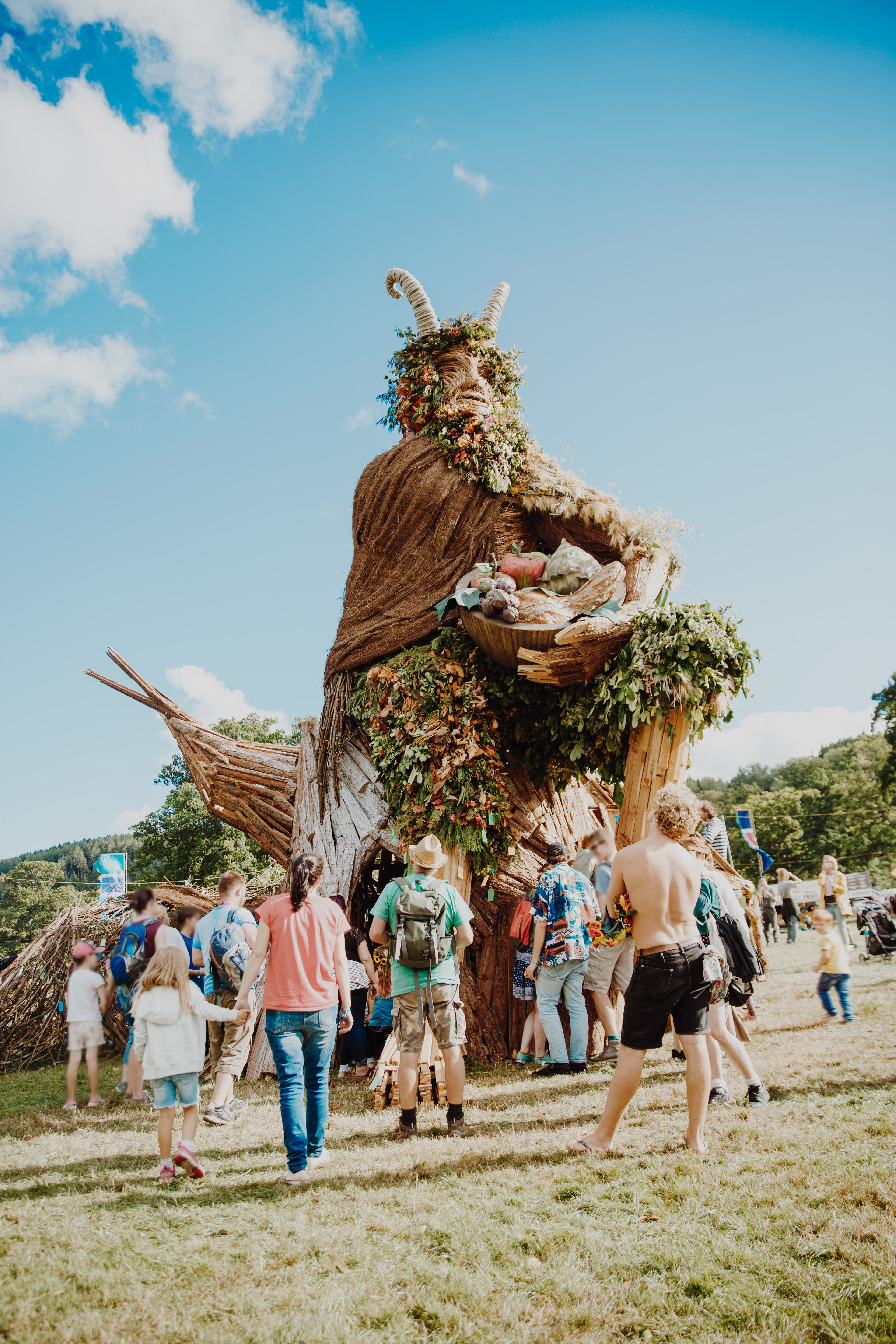 Group of people standing around large sculpture at a festival
