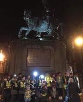 A group being taken on a nighttime ghost walk in Durham