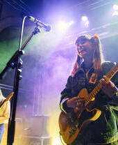 Lady singing and playing guitar at Norwich Arts Centre