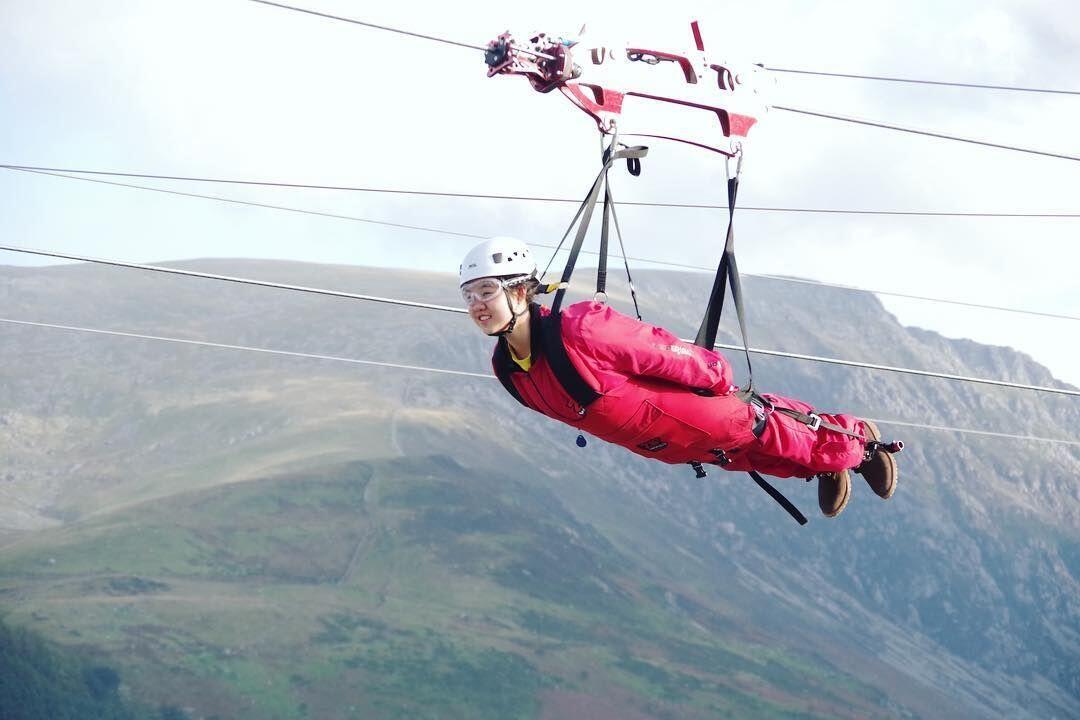Person ziplining over a quarry