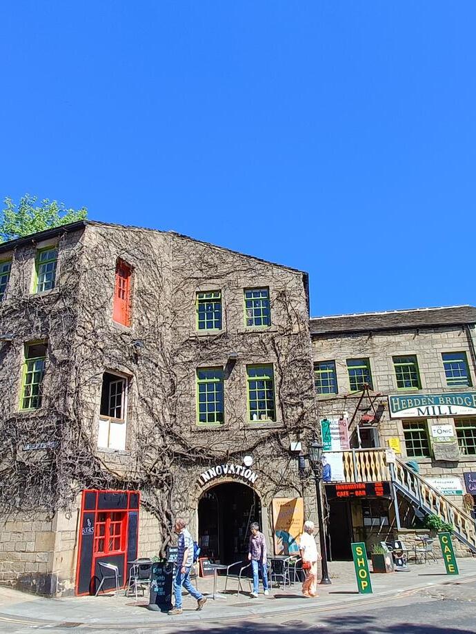 A village mill with passing pedestrians in the centre of an historic country village
