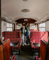 A man and a woman inside a train carriage.