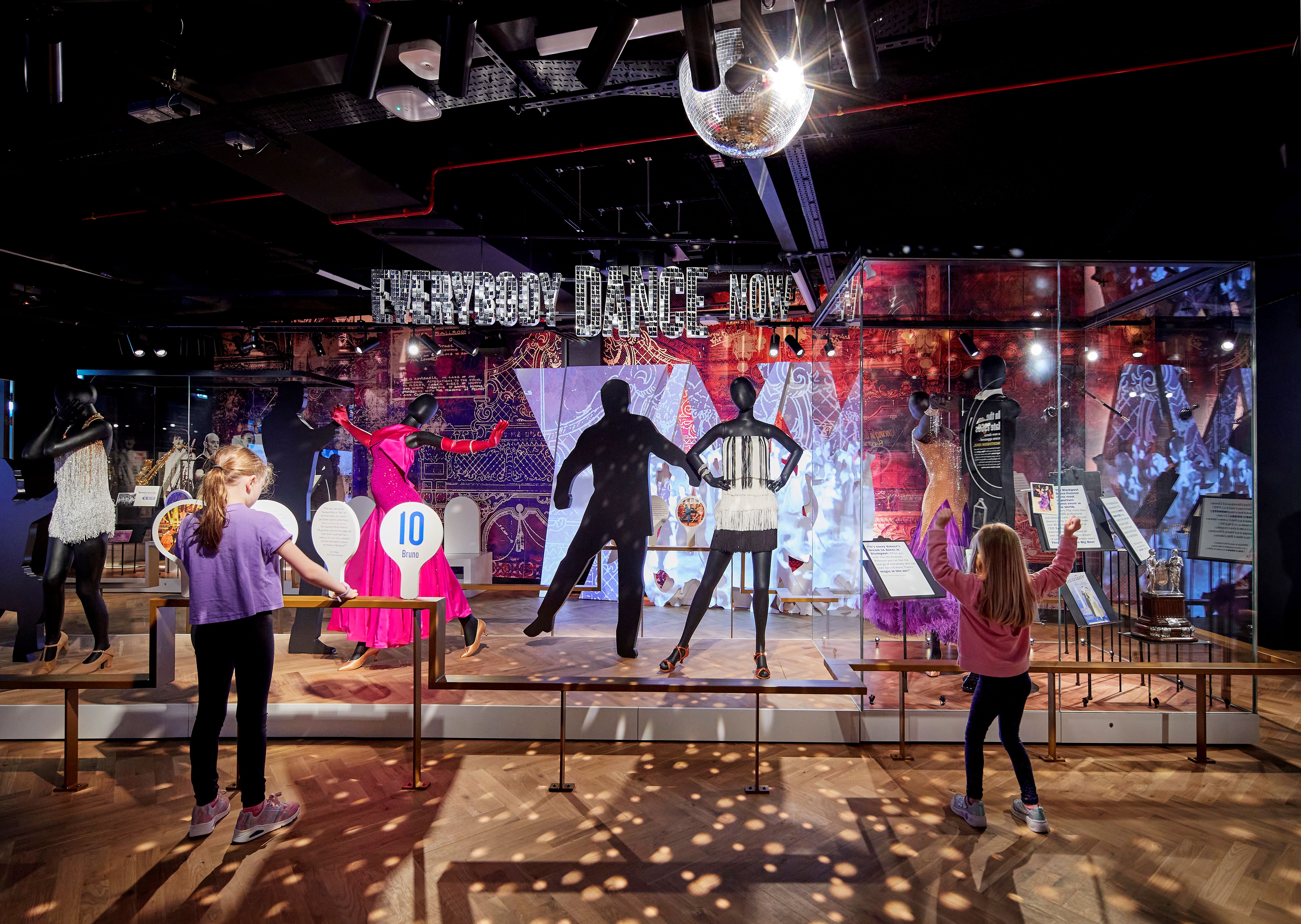 Children looking at a colourful museum exhibit.
