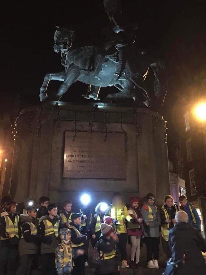 A group being taken on a nighttime ghost walk in Durham