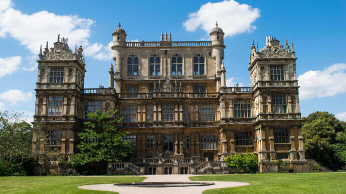 A huge gothic hall on manicured symmetrical gardens.