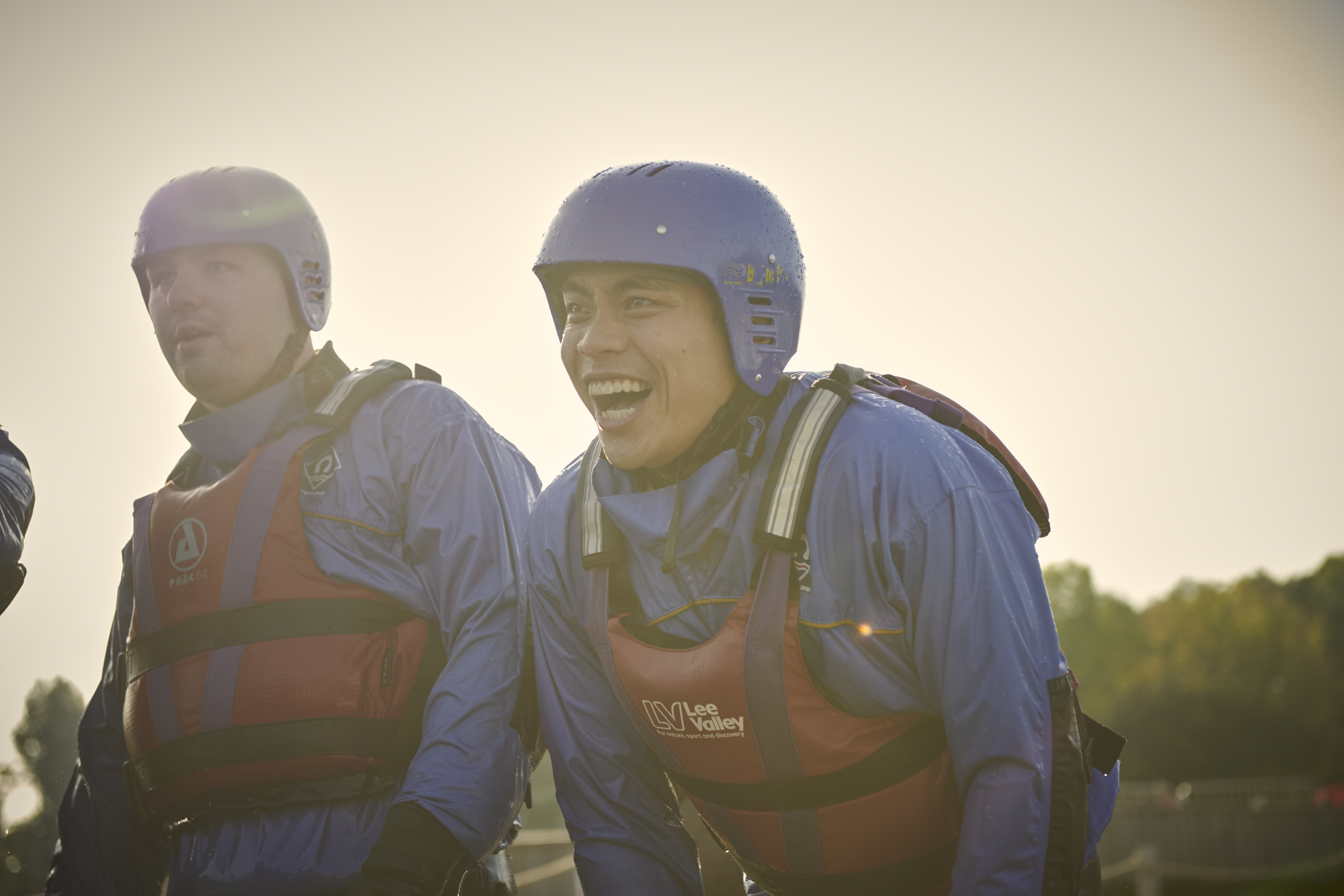 Teenagers standing and laughing wearing protective clothing