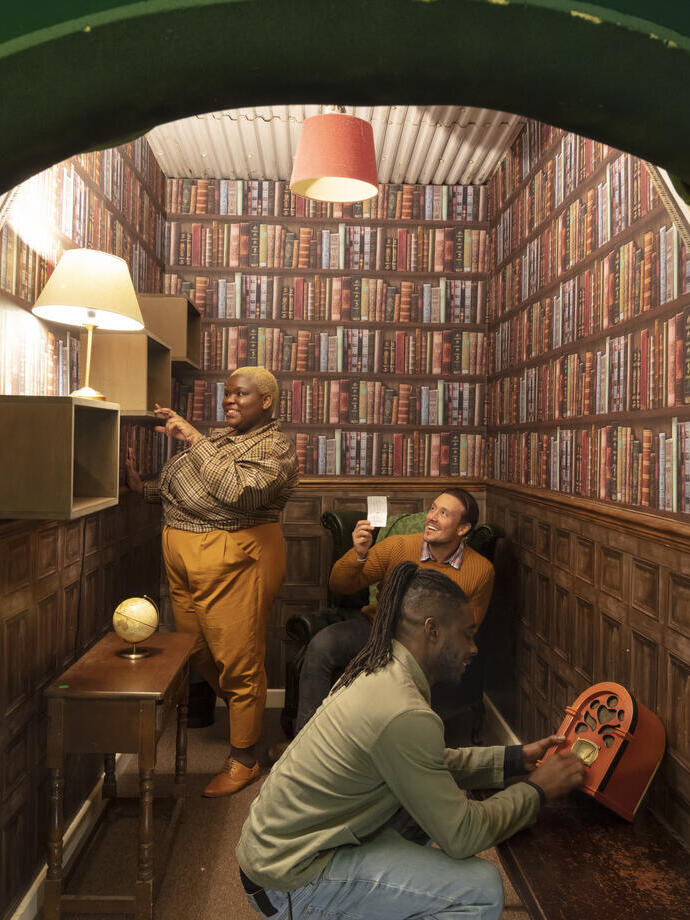 Three friends trying to work their way out of a small escape room style library