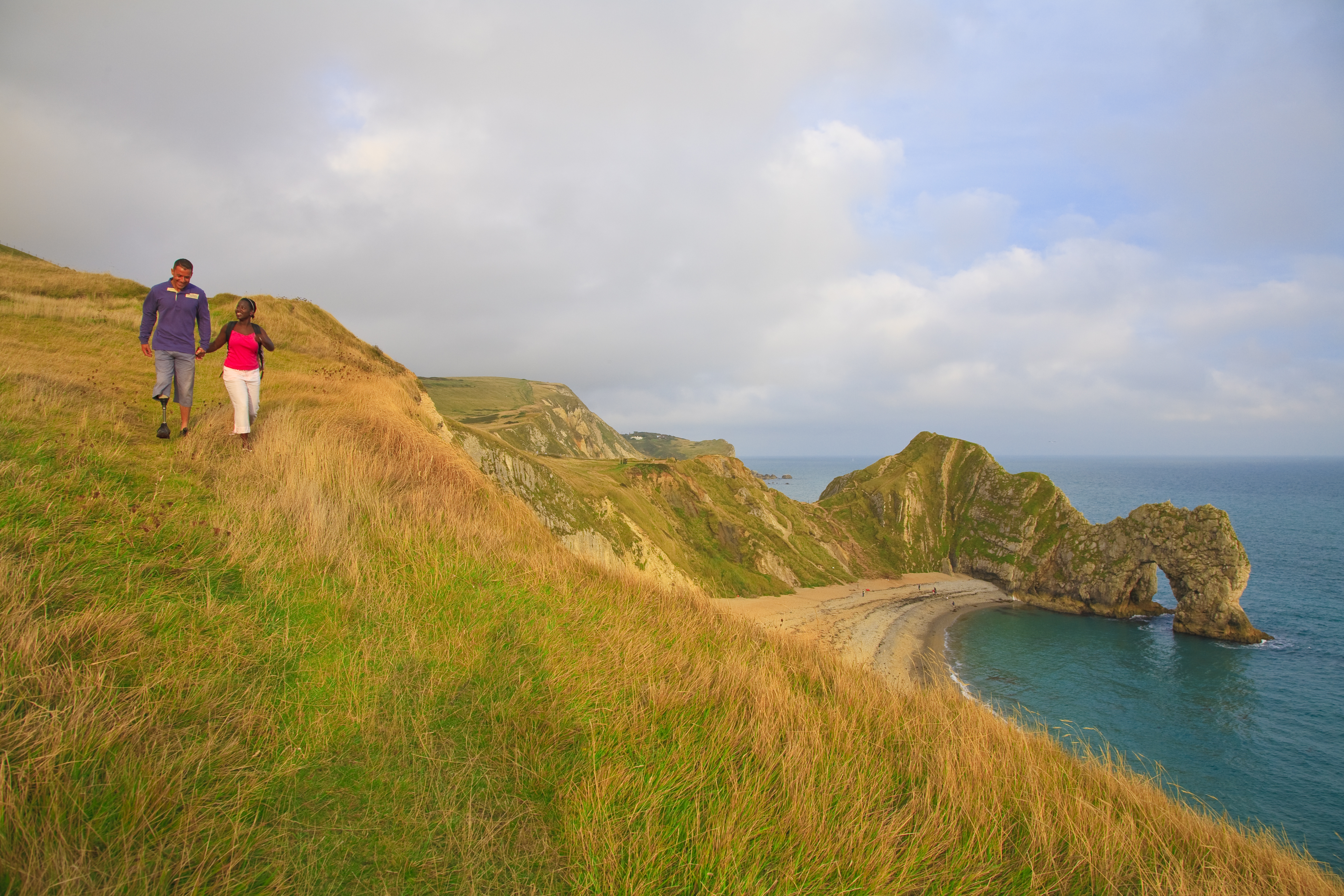 A couple walking on the clifftop in Dorset