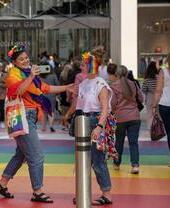 Two women dressed in Pride outfits at Victoria Gate, Leeds
