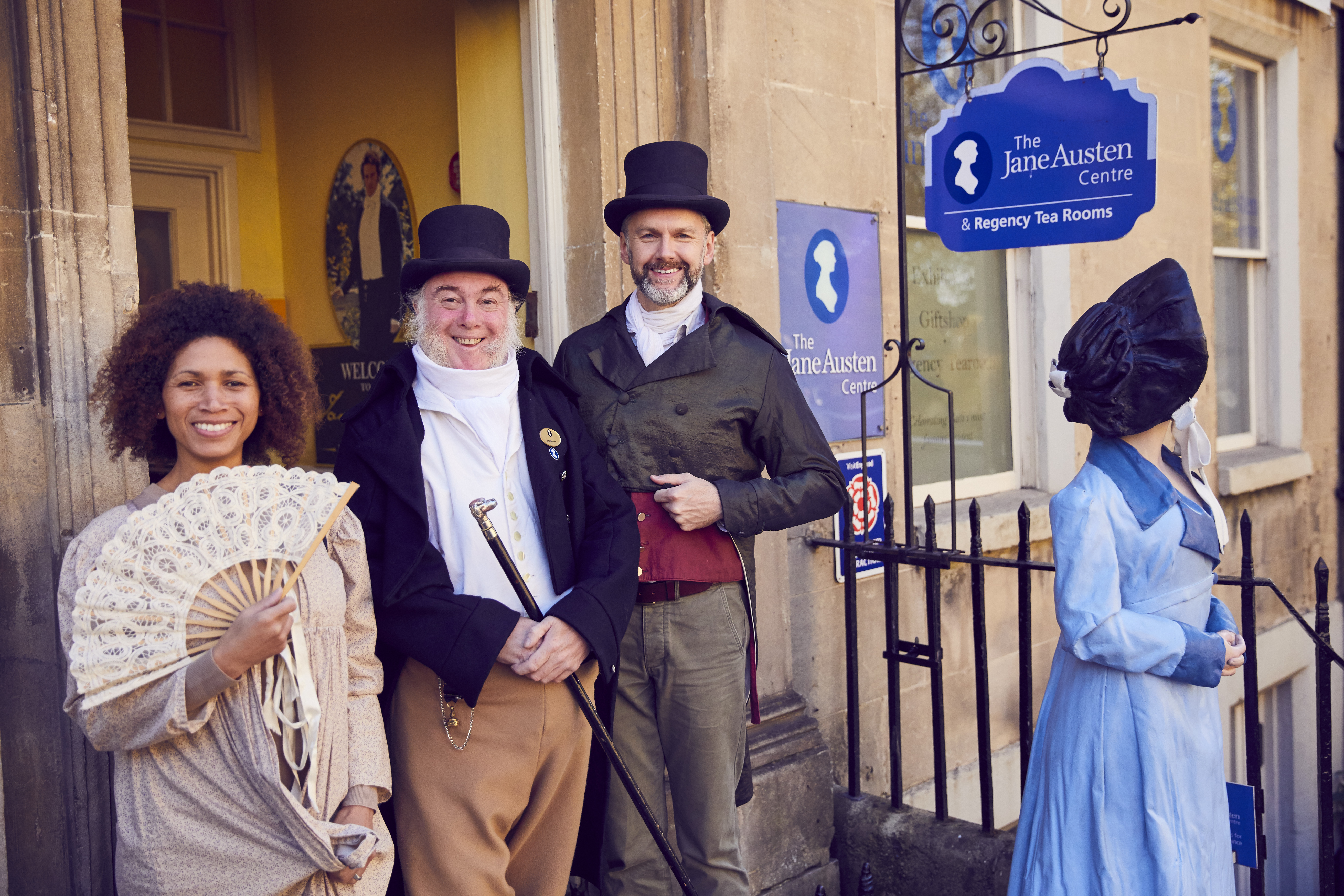 Visitors and staff in period costume outside The Jane Austen Centre, Bath, Somerset, England