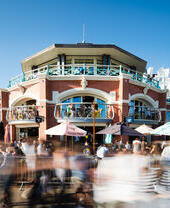 Groups of people eating and drinking outside at Shelter Hall in Brighton