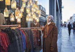 Woman looking at a shop window in the street