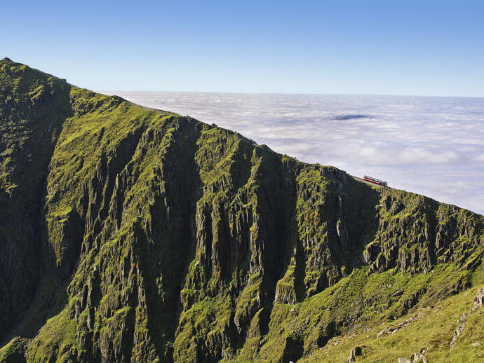 A scenic mountain railway, the final ridge with clouds in the background.
