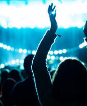 A crowd celebrating a performance at a music venue