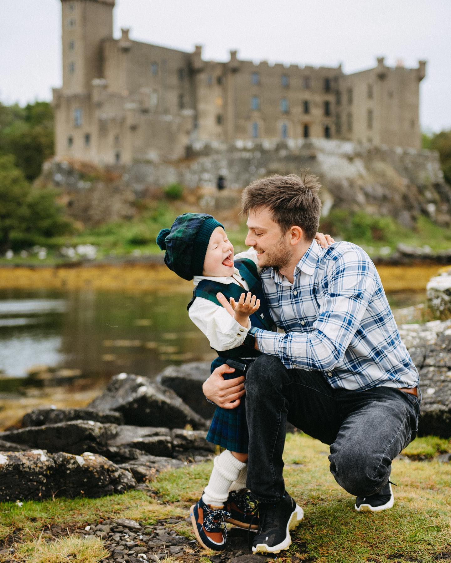 A man and boy outside Dunvegan Castle