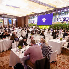 Groups of people sitting at tables discussing business at Destination Britain China