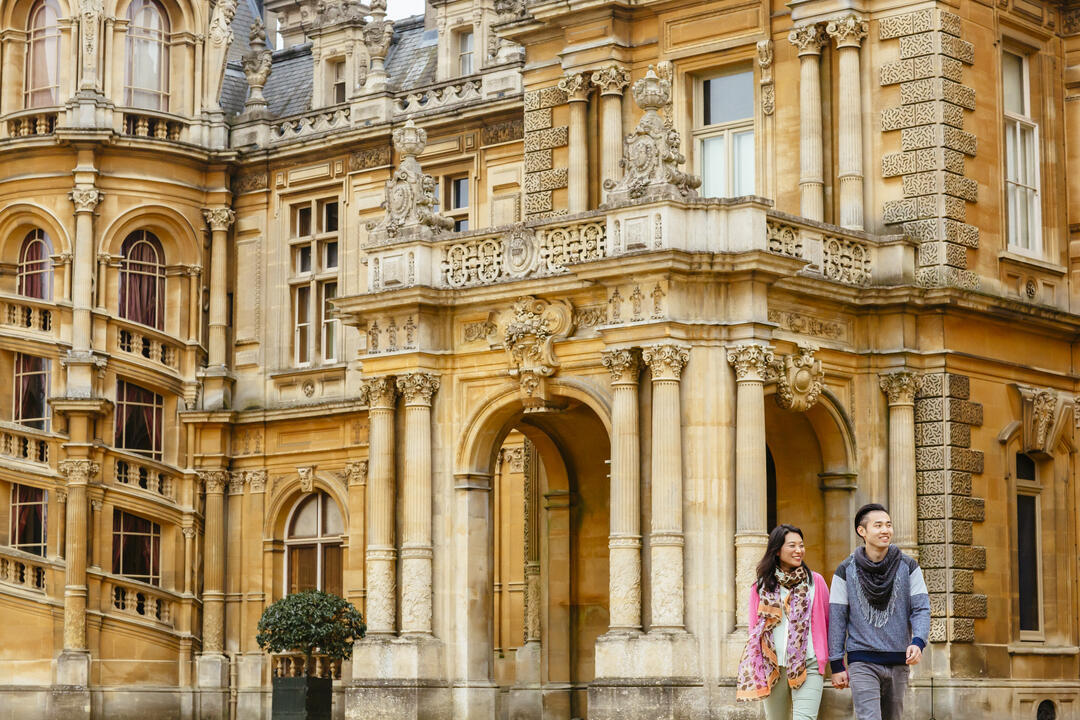 Couple walking outside a stately home