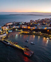 Town on the coast with a harbour in the evening