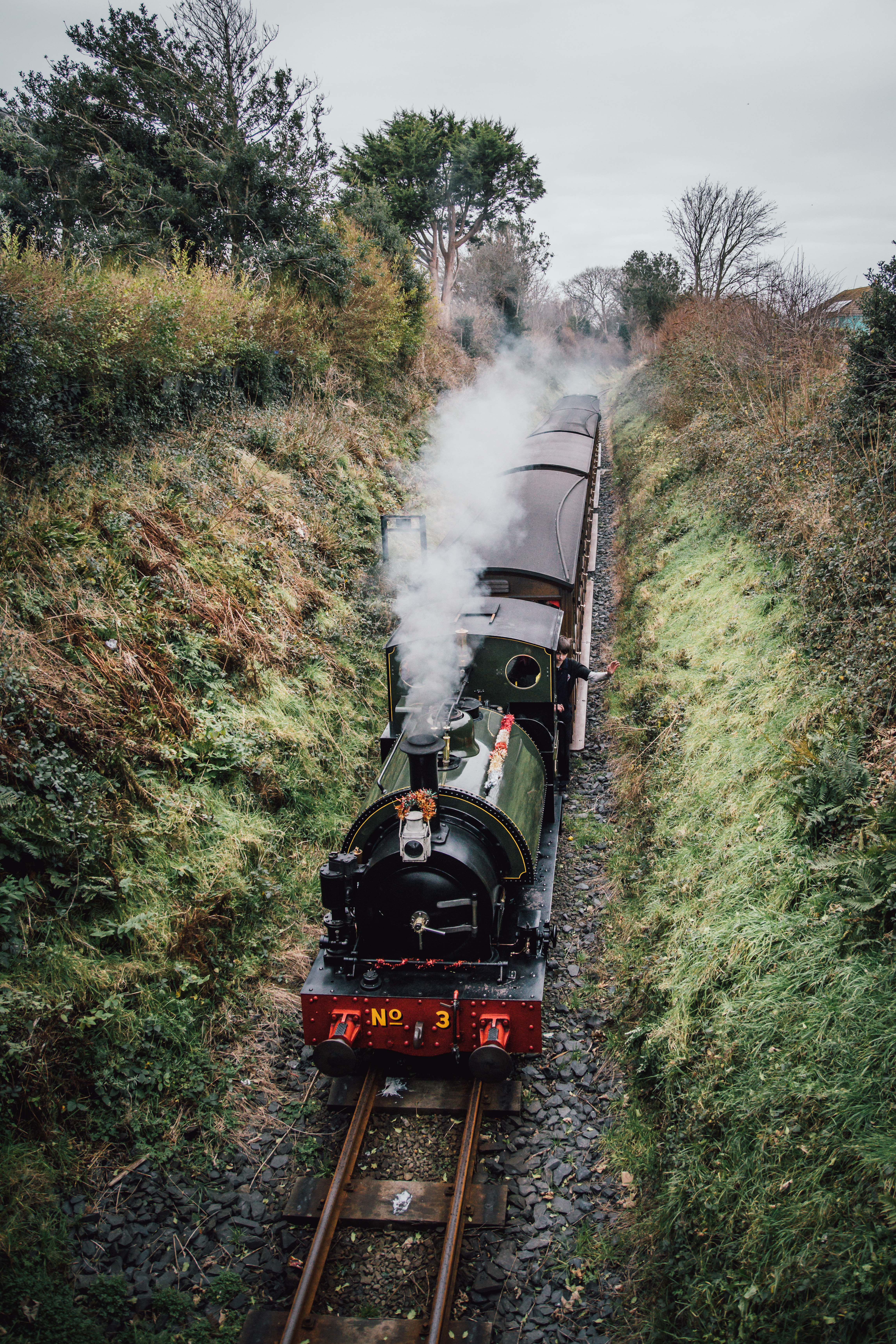 A refurbished heritage steam railway passing through countryside.