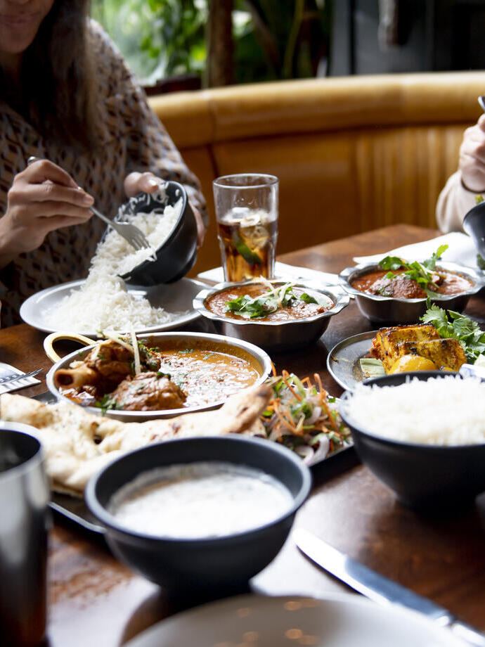 A group of people eating a meal at a table in a restaurant in Birmingham, West Midlands