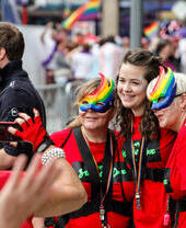 Women in rainbow masks celebrating Pride festival.