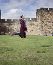 Woman on a broomstick outside a castle