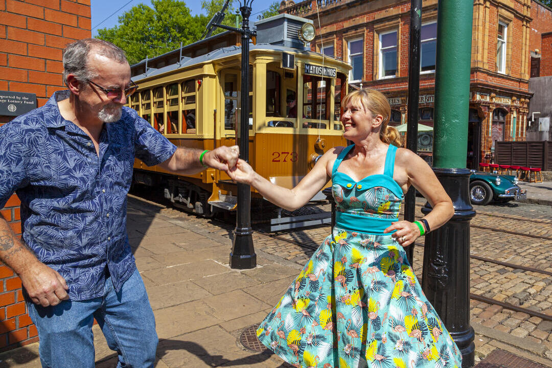 A couple dancing near a tram at Crich Tramway Museum in the Peak District