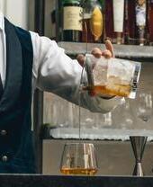Bartender pouring a whisky drink at the Lakes Distillery