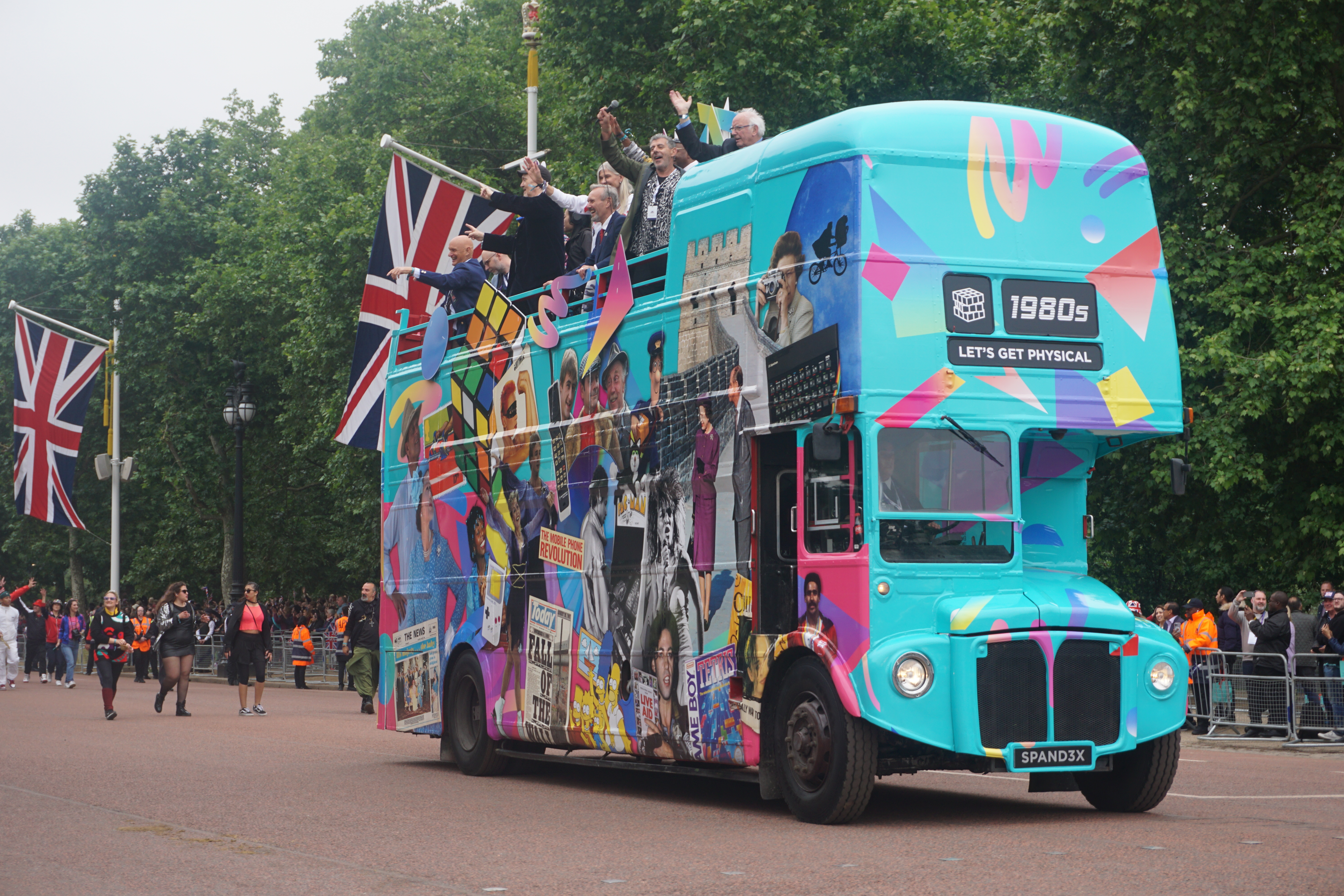 Bild eines blauen Reisebusses mit Union-Jack-Flaggen