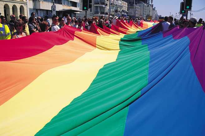 Large Pride Flag being waved in Brighton