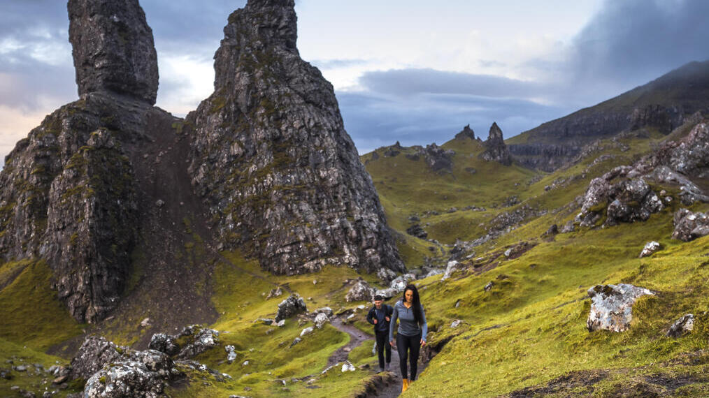زوجان يتنزهان بالقرب من قمم البازلت. سماء ملبدة بالغيوم