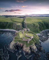 Castle on a rocky outcrop surrounded by sea