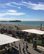 A view above Lucky Beach Café on Brighton beach with views of the pier behind
