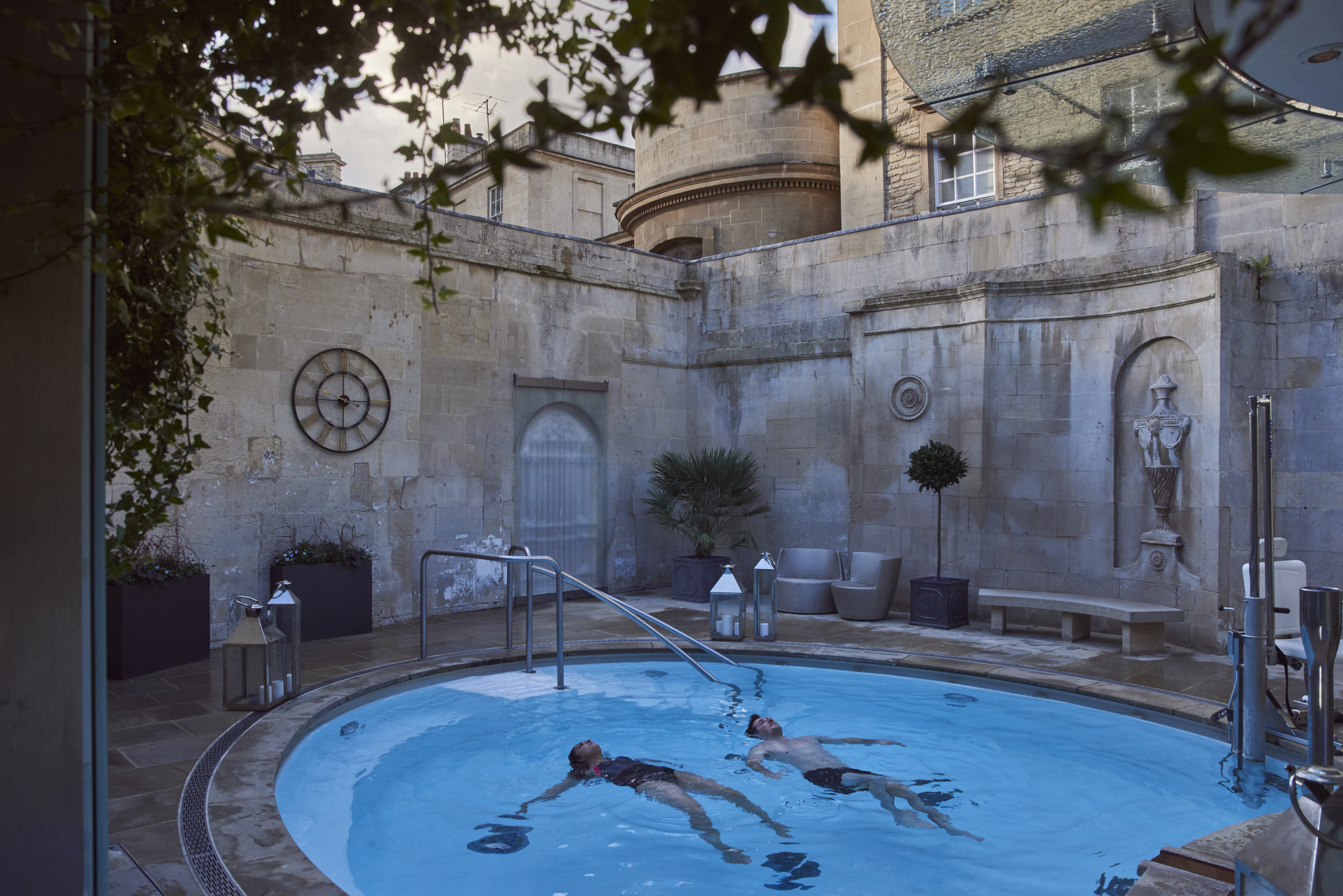 Couple in an open air thermal pool at a spa