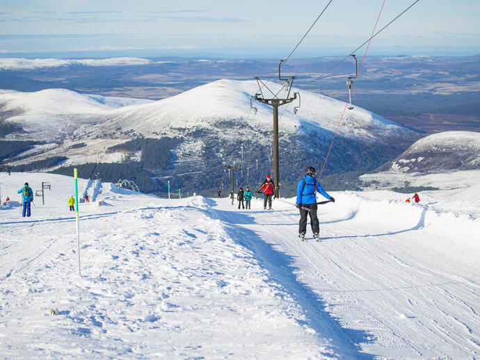 Group of skiers on a snowy slope in the Cairngorms National Park, Scotland