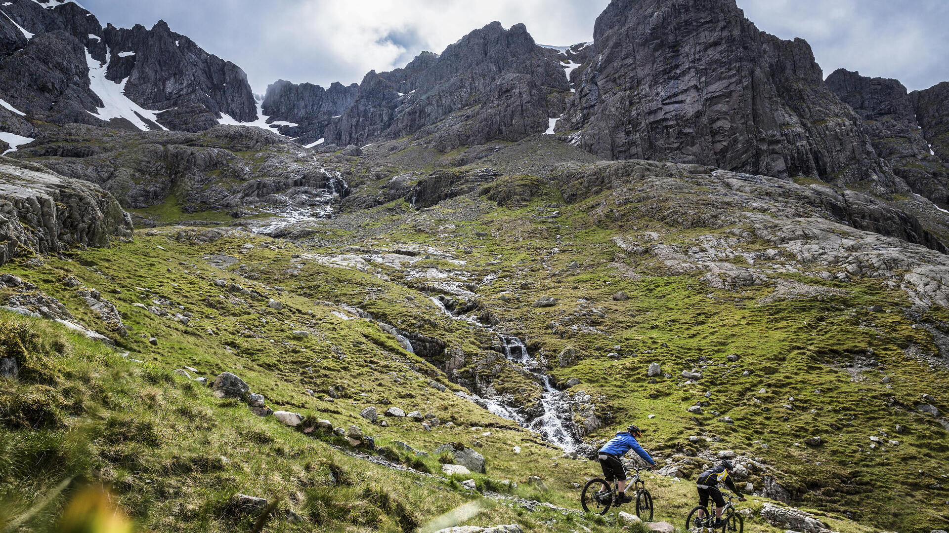 Two mountain bikers cycling down a mountain