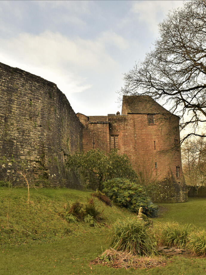 Esterno di un castello in mattoni rossi e mura fortificate in inverno.