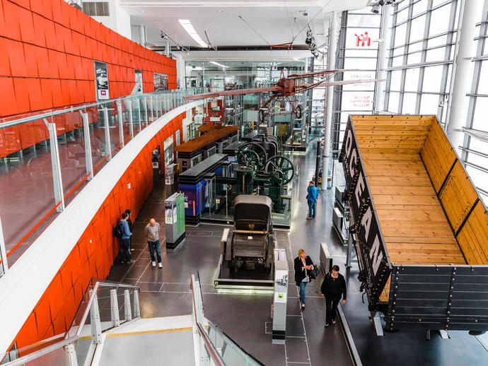 People walking through an exhibit at a modern museum.