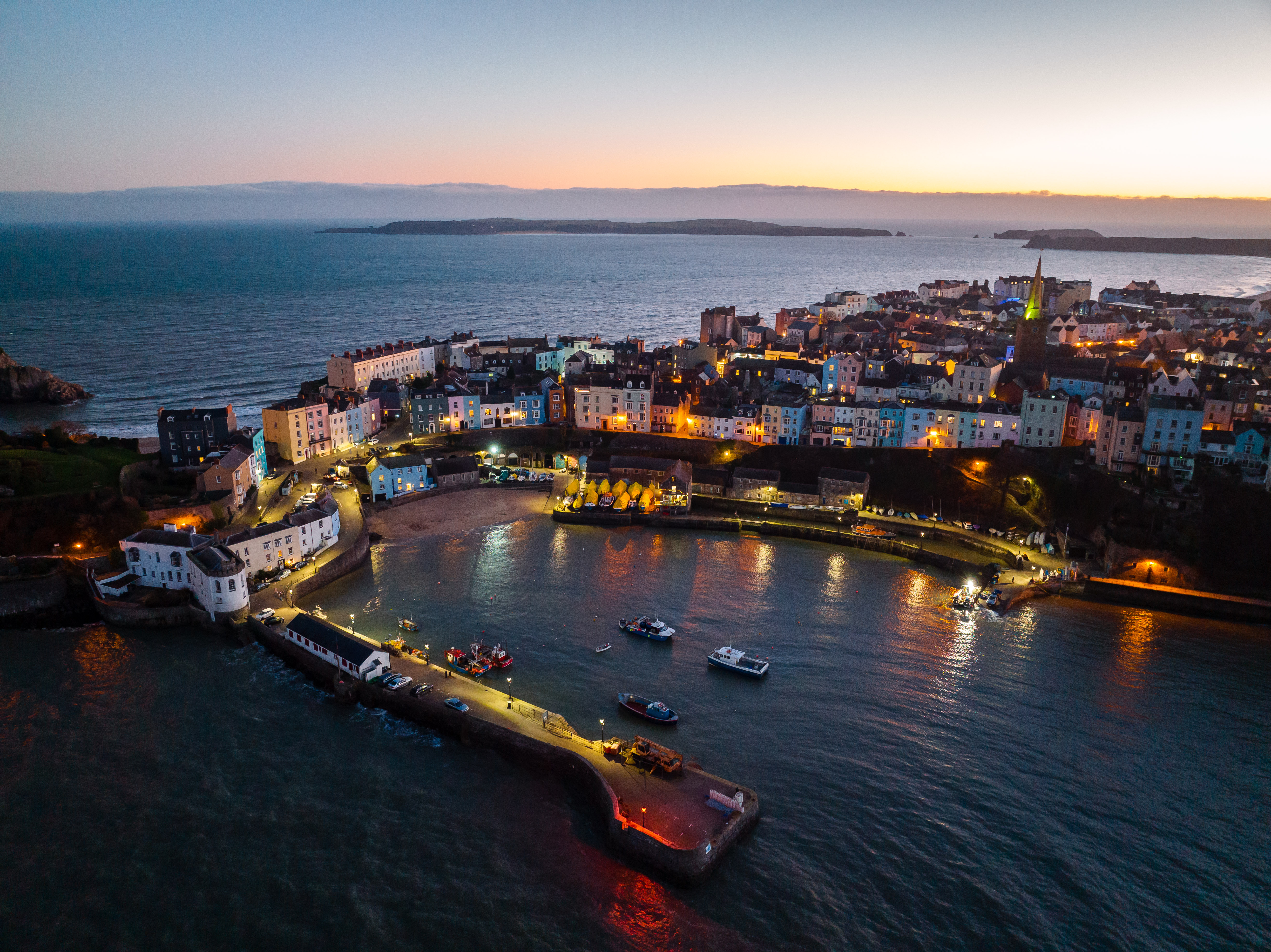 Town on the coast with a harbour in the evening