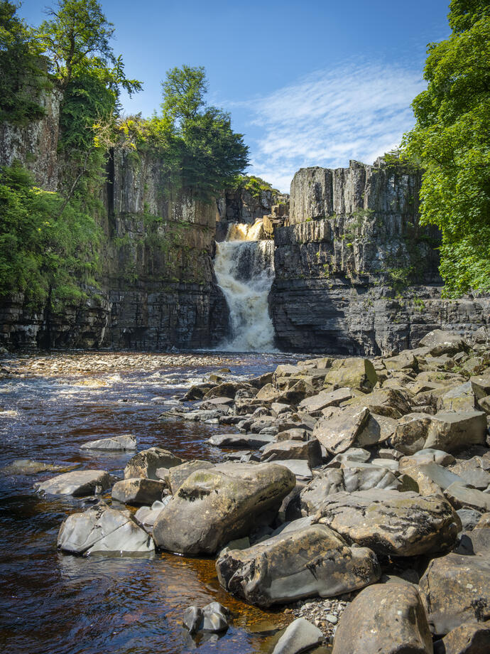 View of an impressive waterfall among rocks