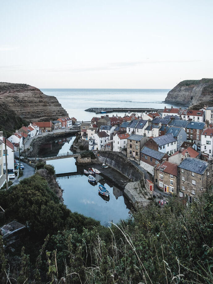 Aerial view of harbour, with boats, and village