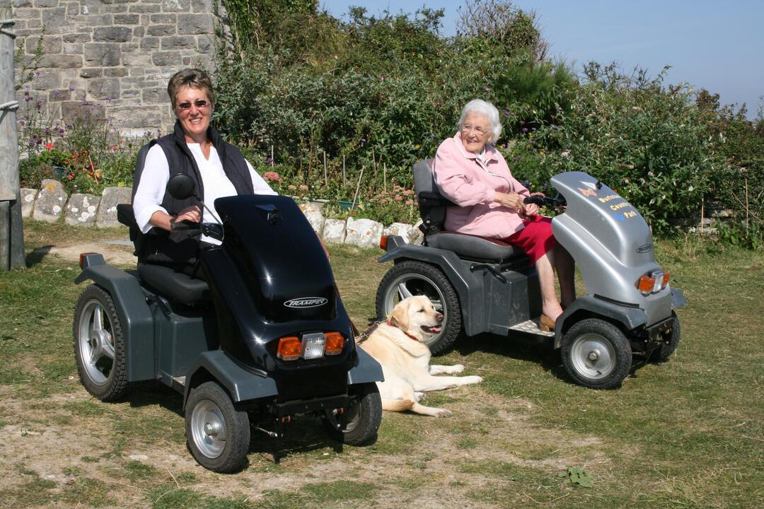 Two women on trampers in a garden