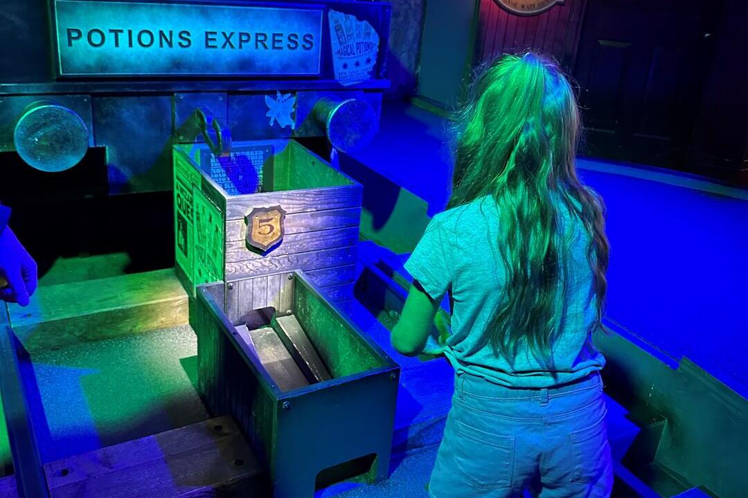 A child enjoying a wizard themed golf experience