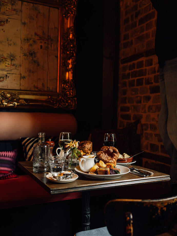 A traditional roast set up on a table inside a country pub.